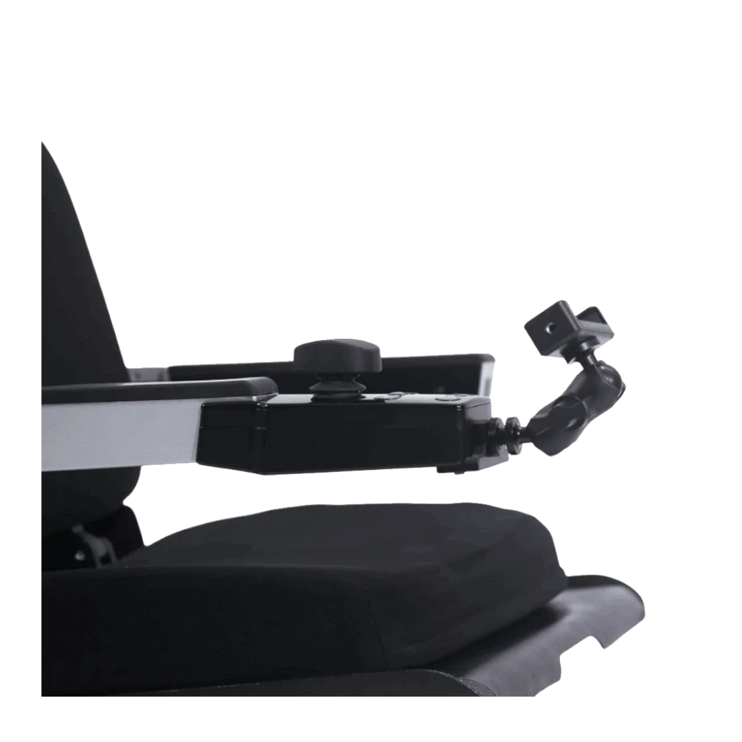 Close-up of the XSTO Phone Holder for the M4 Powerchair attached to a black armrest, showing part of the seat and arm support against a white background.